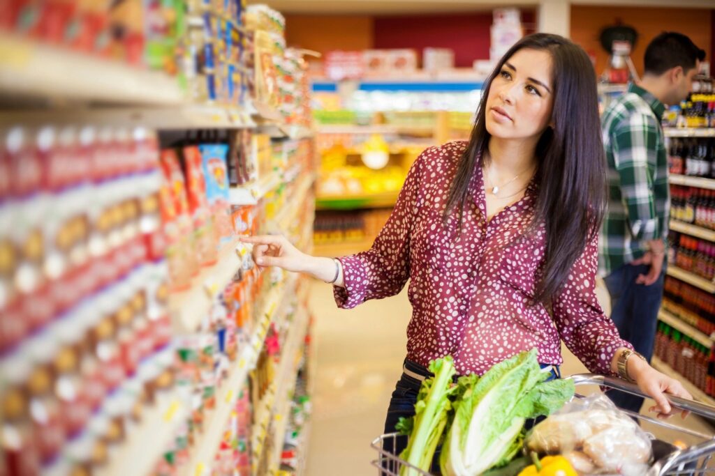 Woman shopping for groceries, representing concierge services offered by our home watch company, including grocery shopping and other personalized assistance.