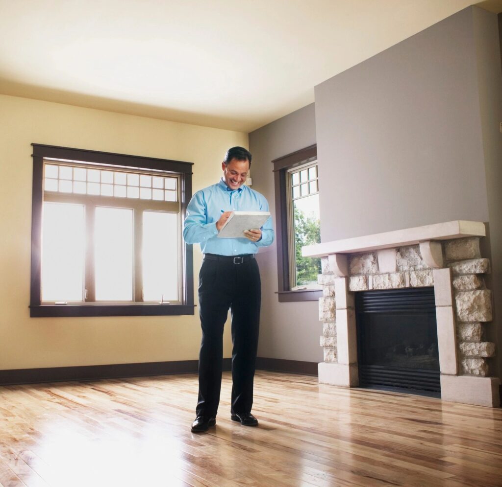 Home watch professional holding a checklist during a house check in an unoccupied house, showcasing detailed and reliable home watch services