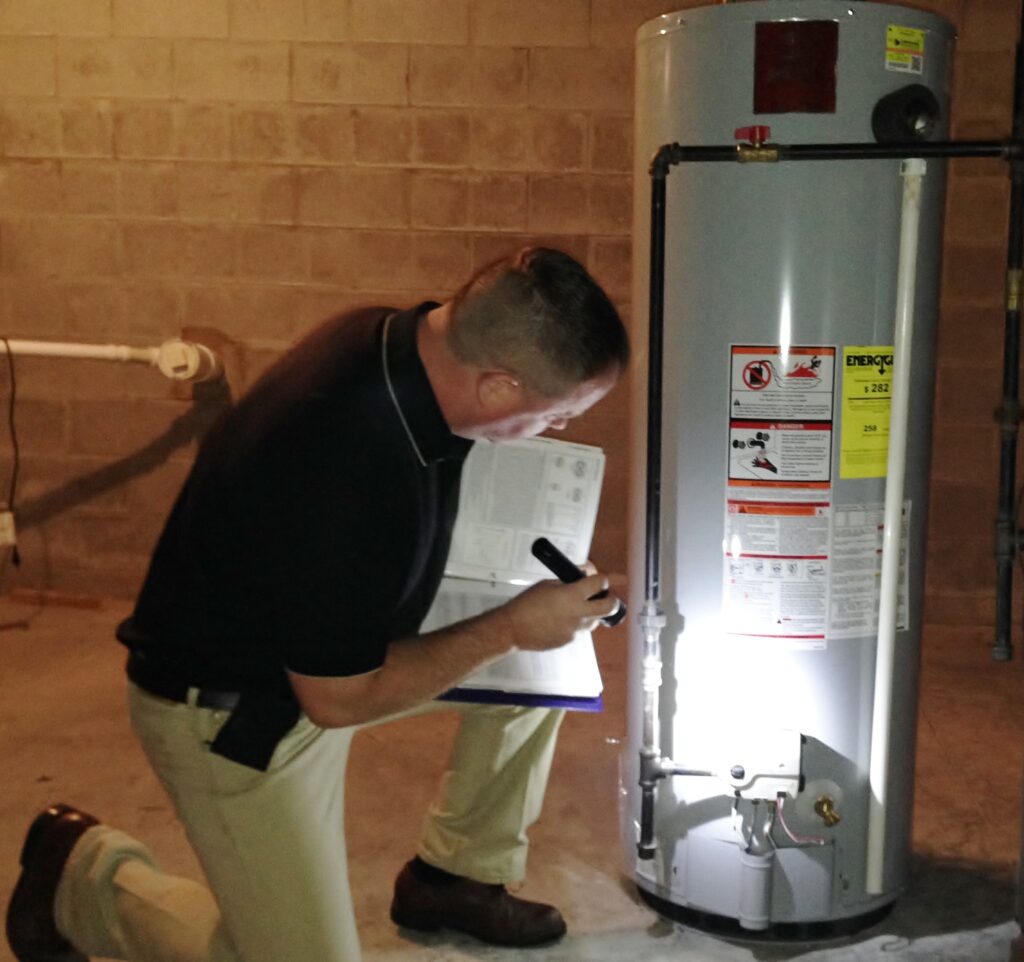 Dan Powell conducts a detailed inspection of a water heater during a home watch visit in Rochester, NY. This thorough check ensures that the water heater is operating efficiently and free from issues, helping to maintain the overall functionality and safety of your home while you're away.